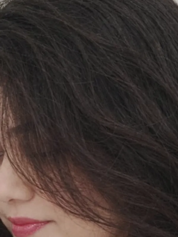 Dark waves of Manu’s hair catching the light.