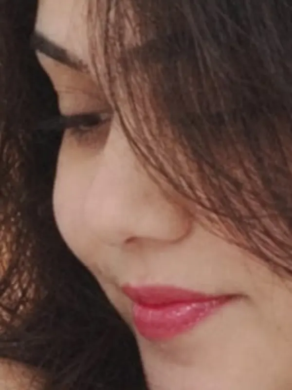 Close detail of Manu’s lowered eyes and hair.